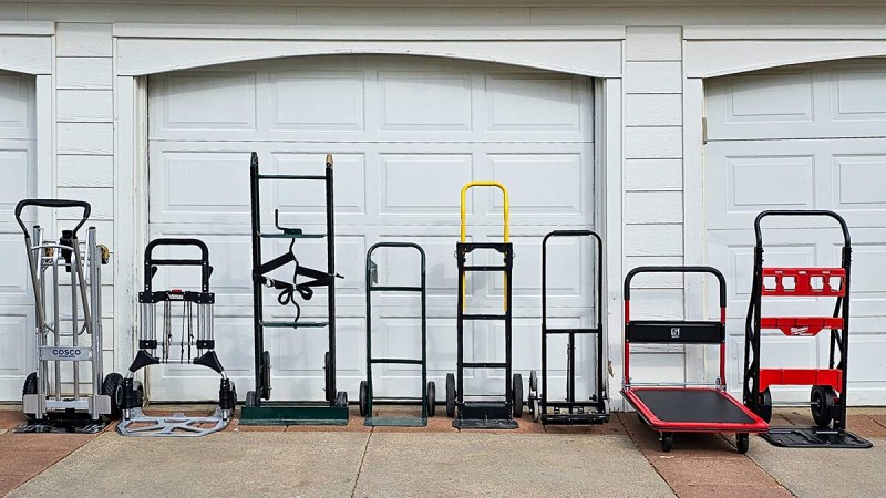 A group of the best folding hand trucks in front of a garage door before testing.