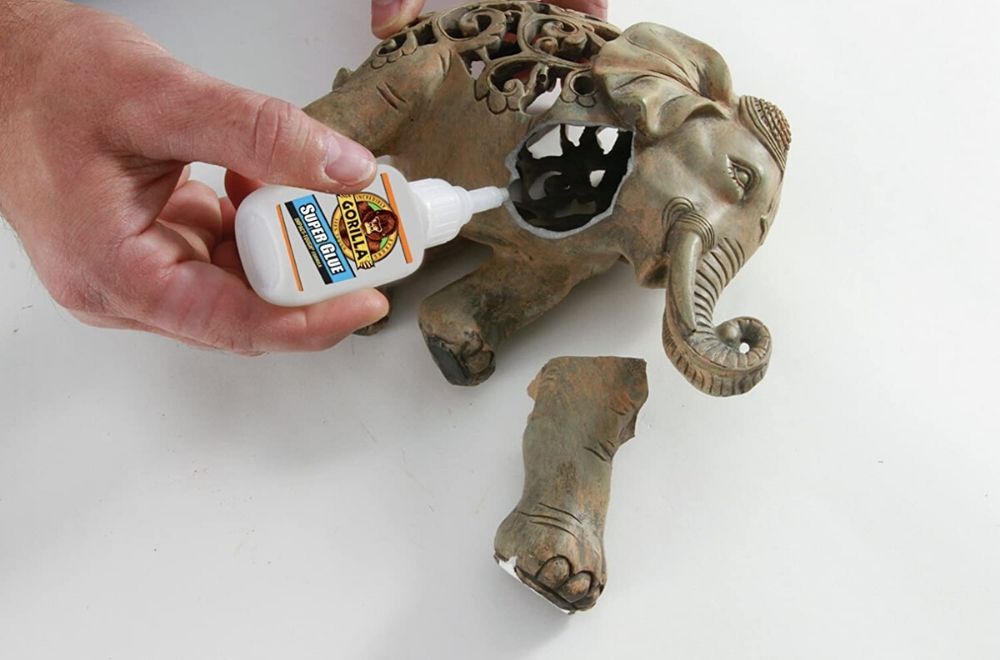 Gorilla super glue being used to repair an elephant figurine