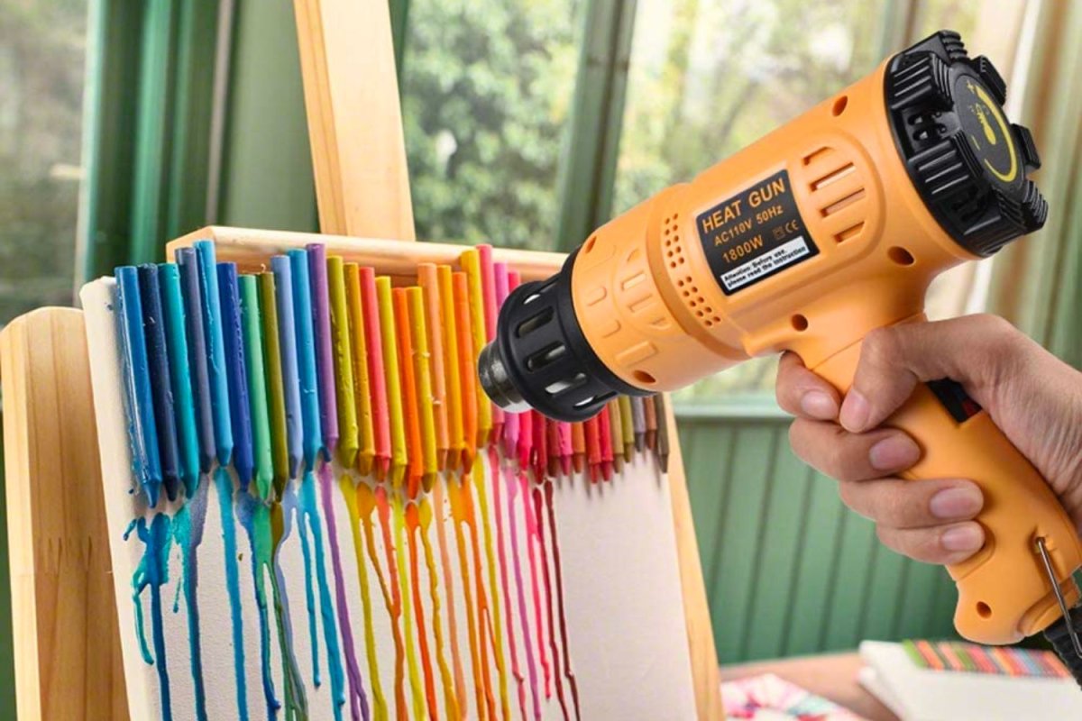 A person using the best heat gun option to melt colorful wax for an art project