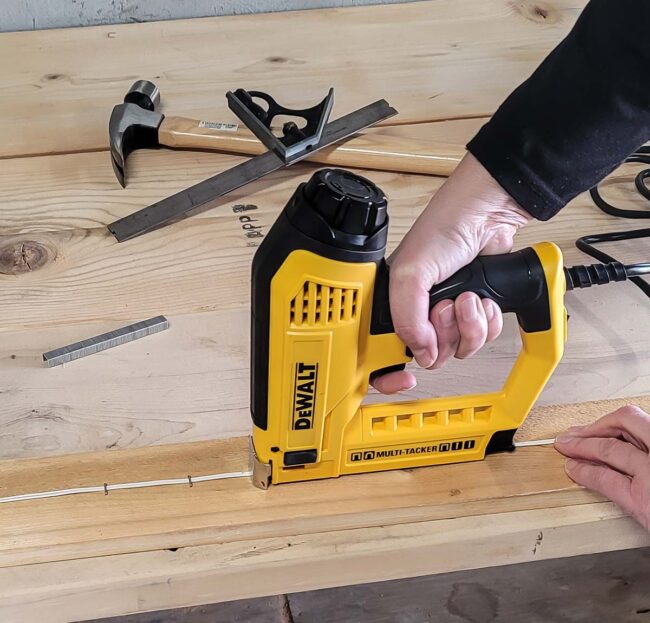 A person using a DeWalt brad nailer