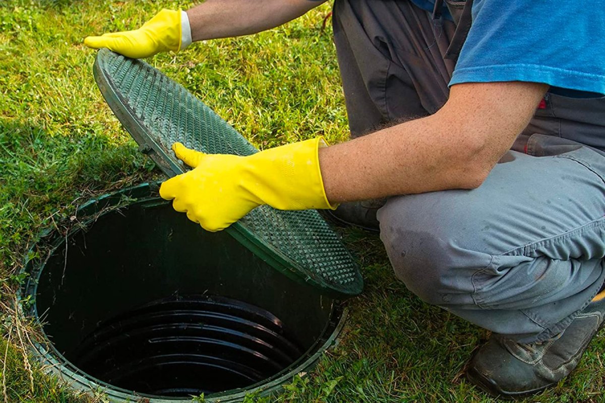 A woman pouring the best septic tank treatment option into a toilet