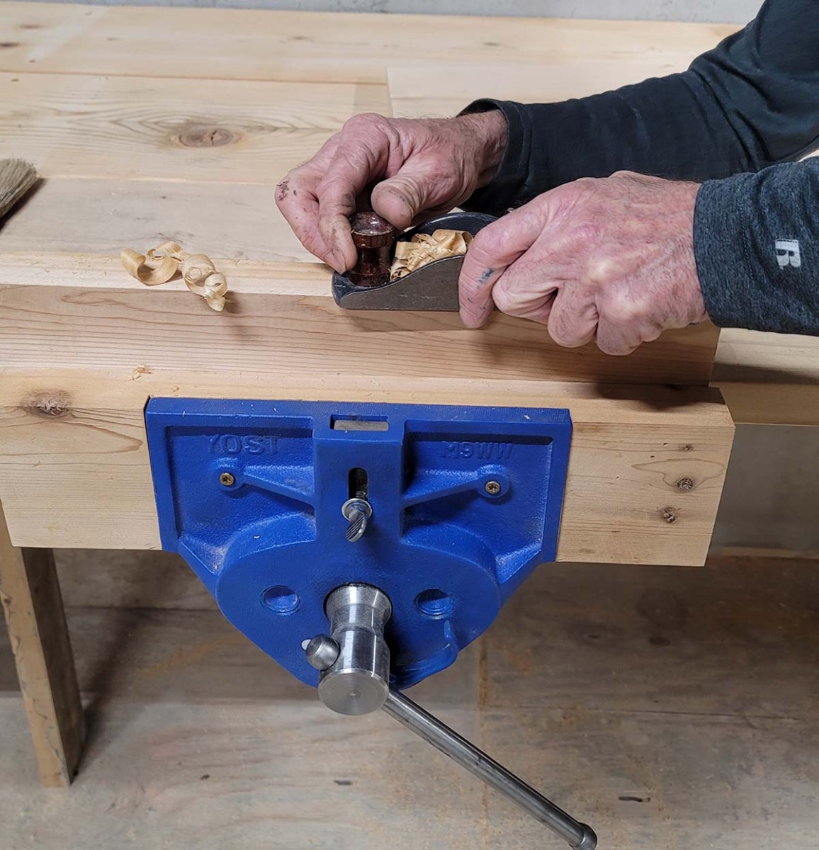 Man working on one of the Best Bench Vises options