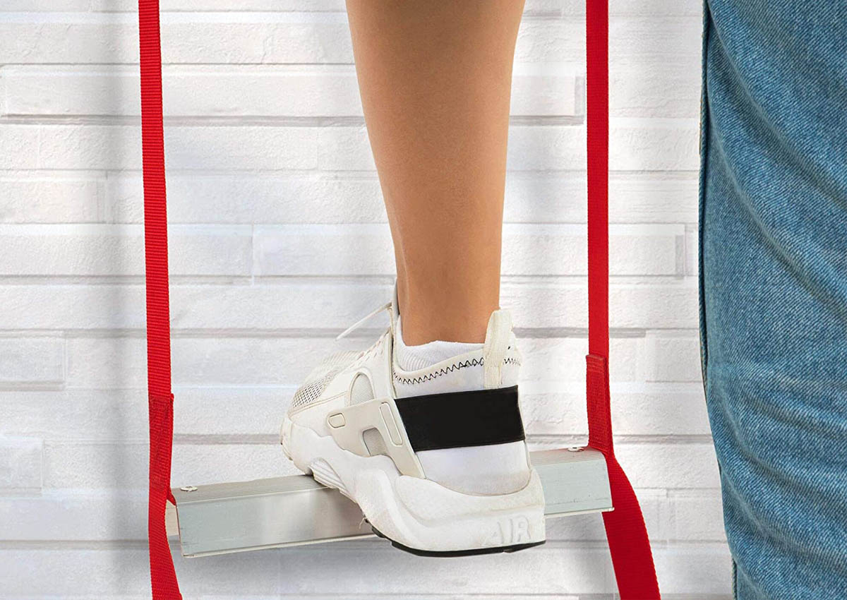 A person wearing tennis shoes while they step on one rung of the best fire escape ladder.