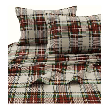  The Tribeca Living Flannel Extra-Deep-Pocket Sheet Set in a red, green, and white plaid pattern on a bed.