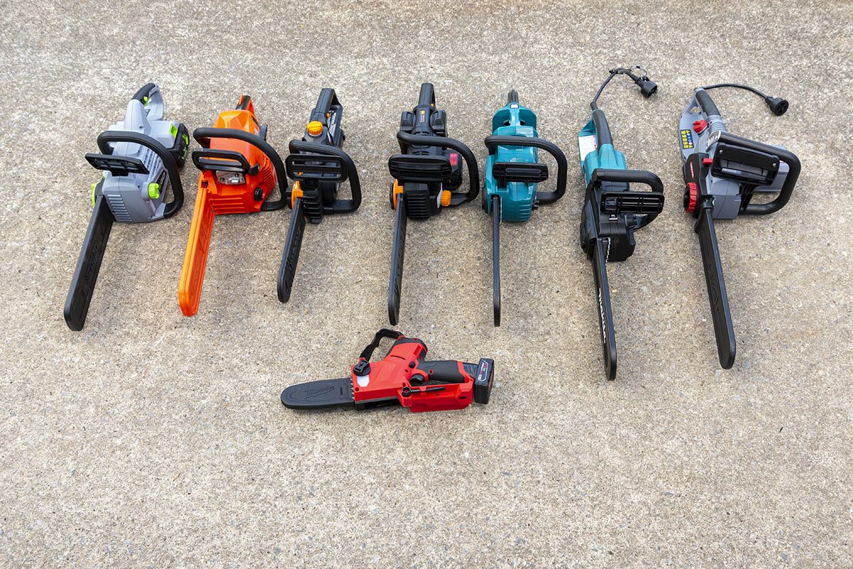 8 small chainsaws lined up on the ground