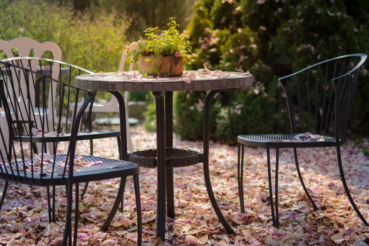 Fall patio furniture covered in leaves.