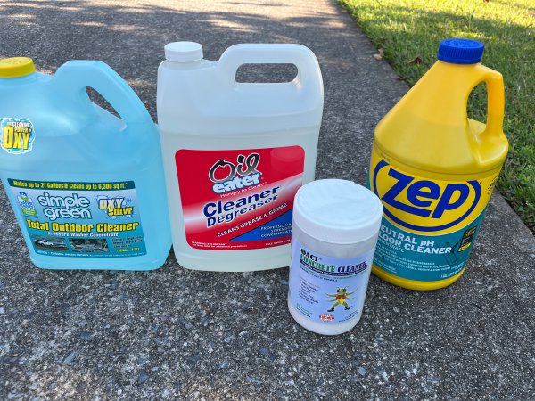 A group of concrete cleaners on a concrete driveway