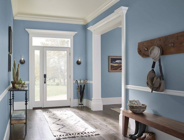 A home entryway with painted blue walls and white trim