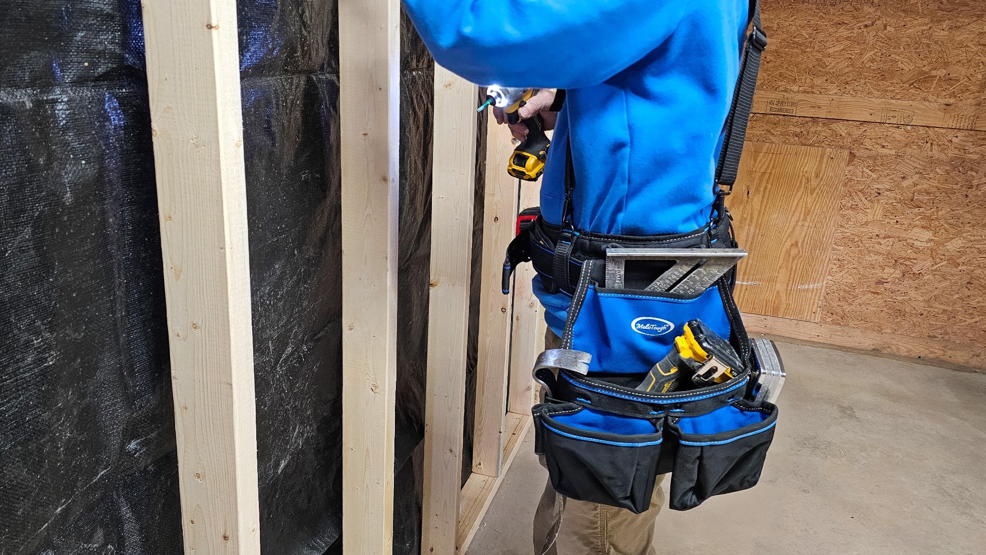 a man working with Melotough Pro Framer’s Tool Belt