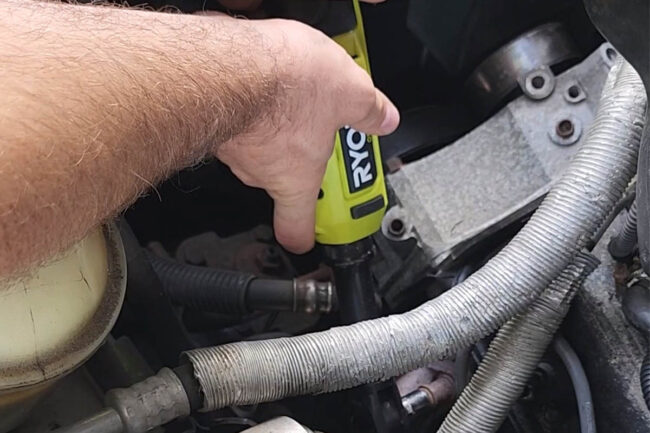 A person using a Ryobi cordless ratchet