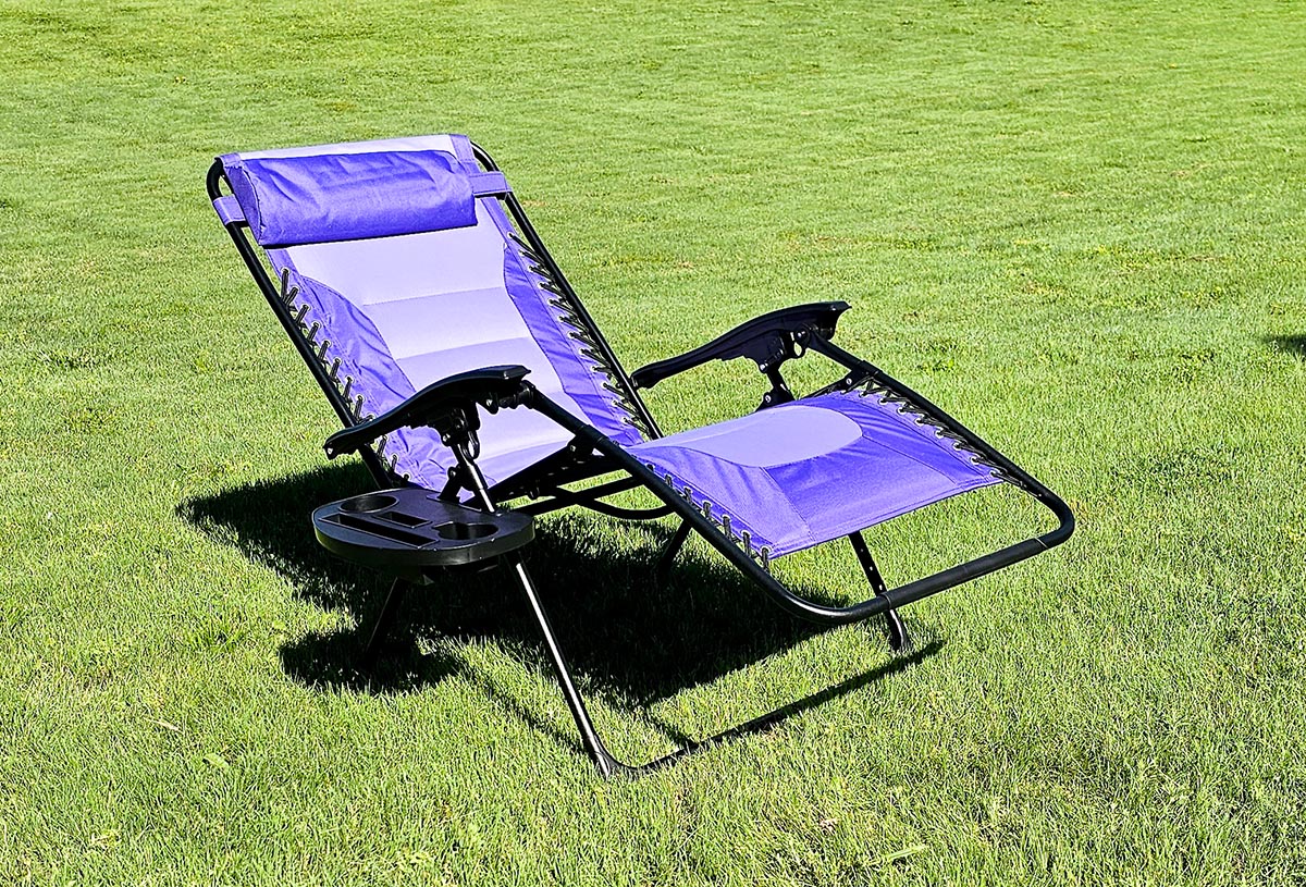 Purple zero gravity chair reclining on grass