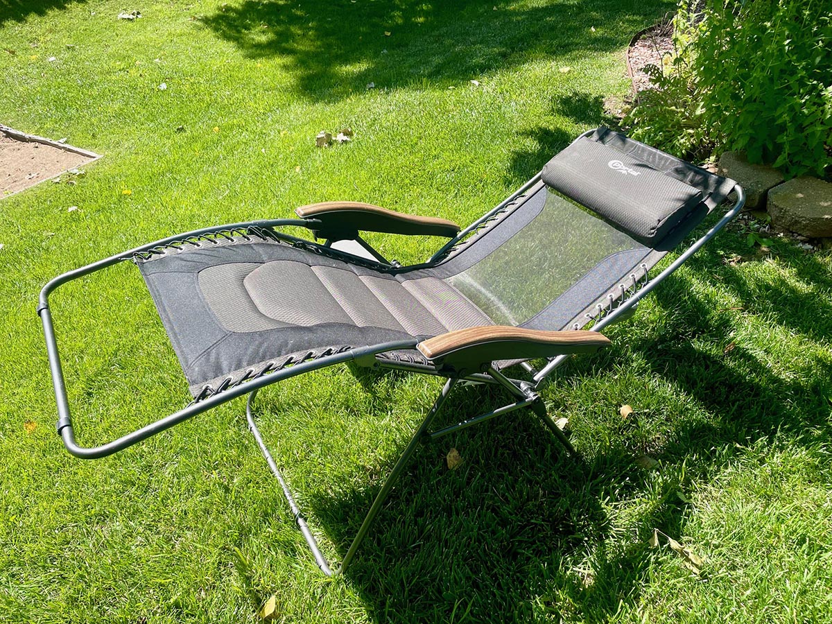 Black zero gravity chair reclined on a lawn