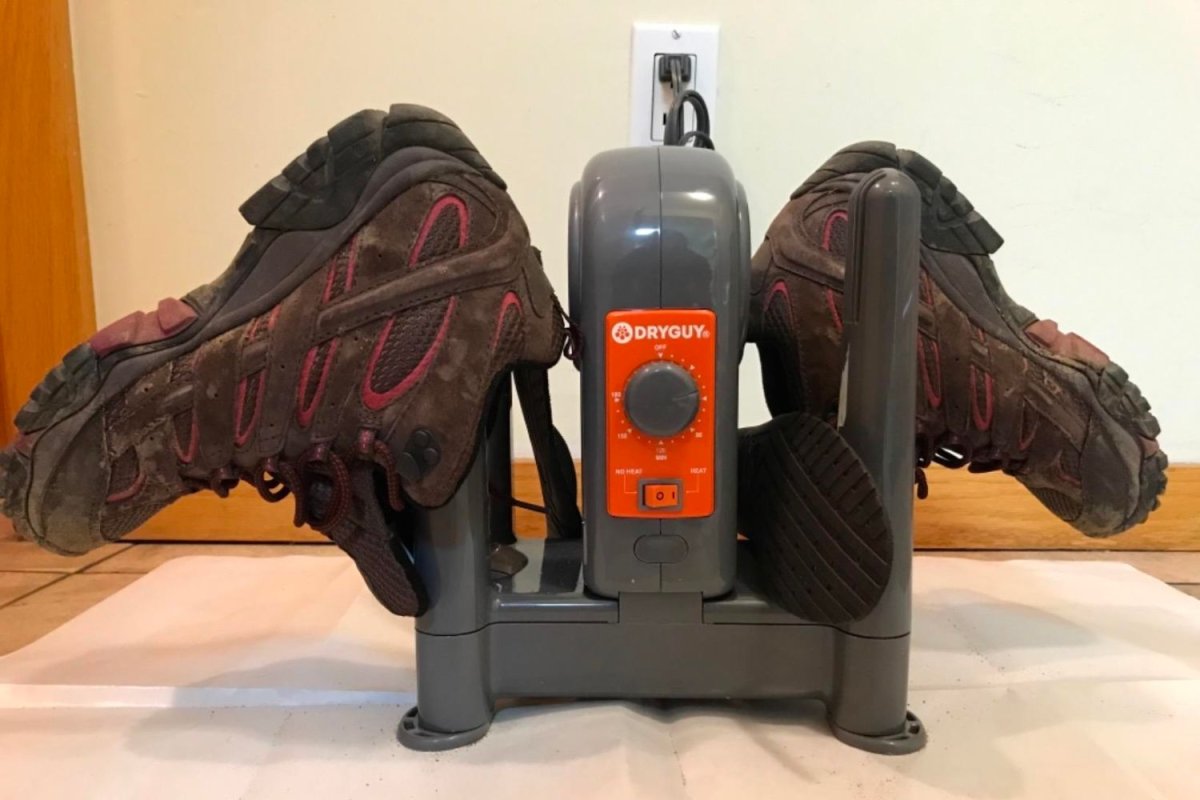 The Best Boot Dryers Option set up on a tile floor and turned on to dry a pair of boots.