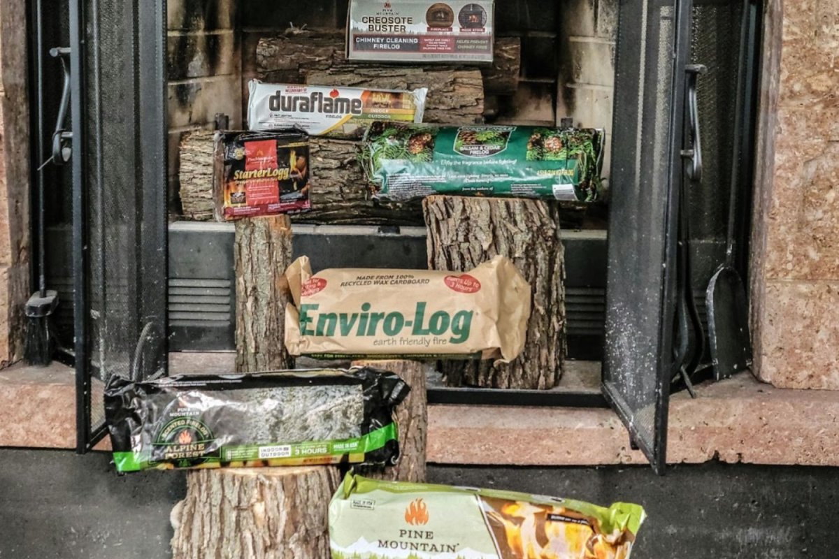 A group of the best fire logs placed together in their packaging on logs in a wood-burning fireplace.A group of the best fire logs placed together in their packaging on logs in a wood-burning fireplace.A group of the best fire logs placed together in their packaging on logs in a wood-burning fireplace.