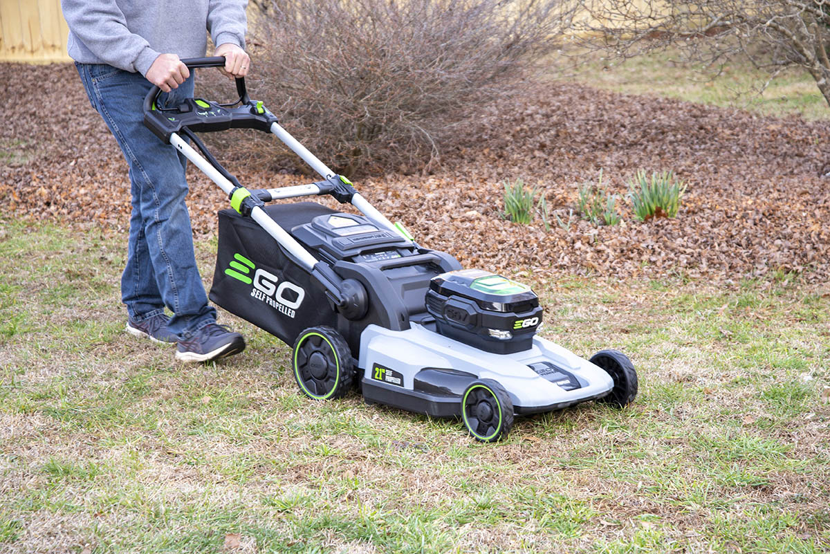 A person using the Ego Power+ 21" Self-Propelled Lawn Mower to mow a lawn during testing.