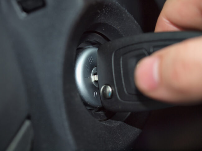 Hand with key and the ignition switch