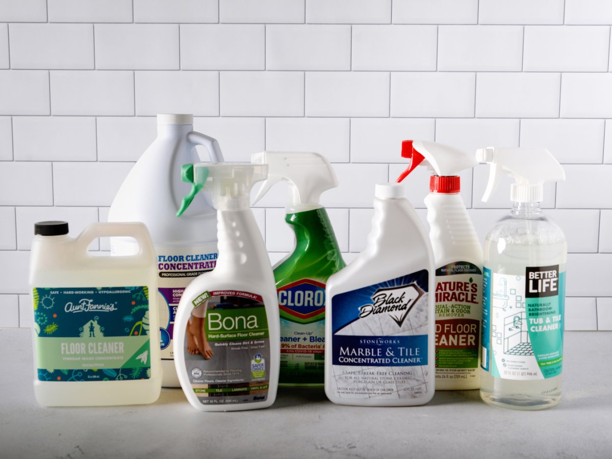 A group of the best tile cleaners group together in front of a tiled wall before testing.