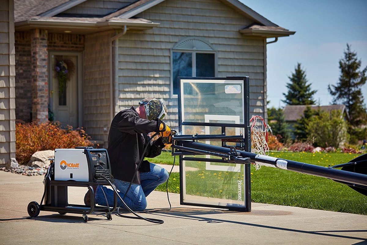 A welder using the best welder option to weld the frame of a basketball hoop backboard