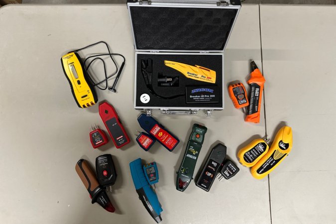 Multiple circuit breaker finder tools lined up on a floor