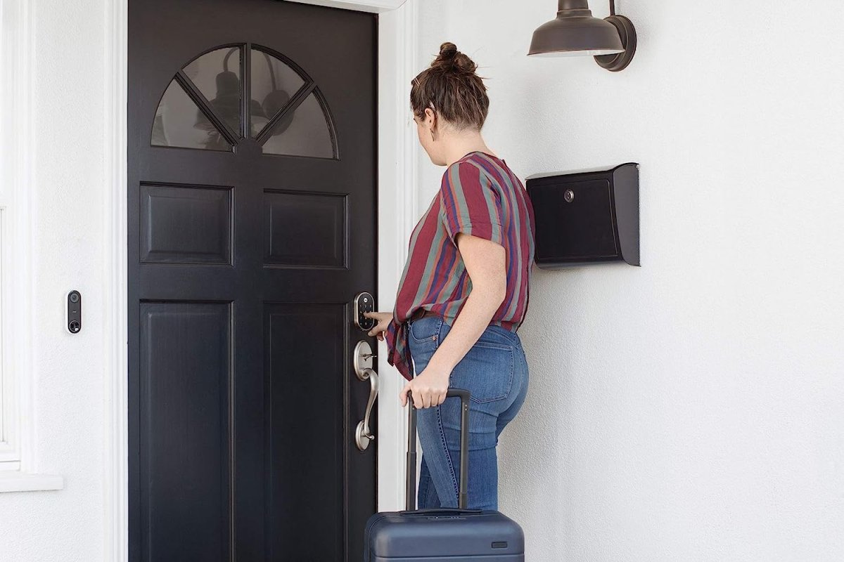 A person with a suitcase entering a code on the best keypad door lock option