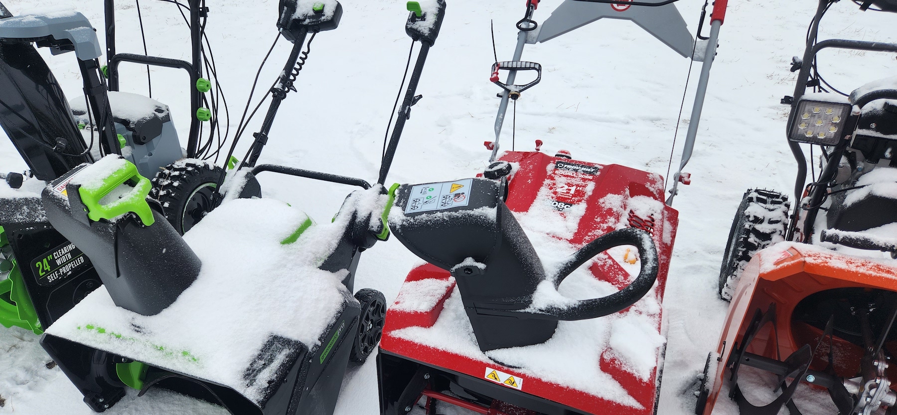 A close-up photo of single stage snow blower after use with snow on it