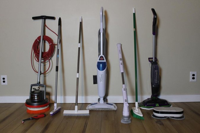 A group of the best floor scrubbers leaned against a wall before testing.