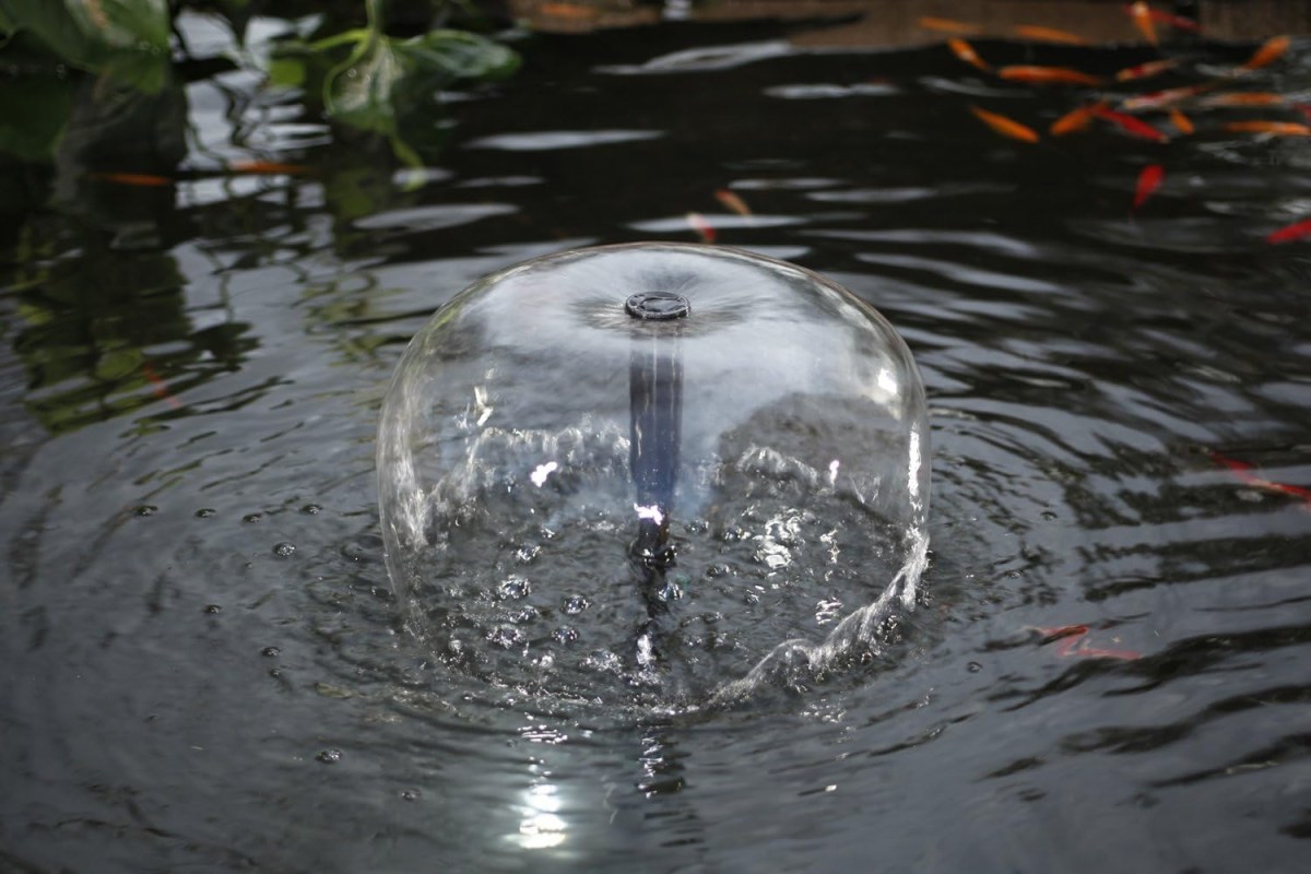 A pond pump spraying water on a pond surface