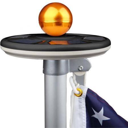  The Sunnytech 3rd Generation Solar Light for Flagpoles at the top of a flagpole with the American flag.