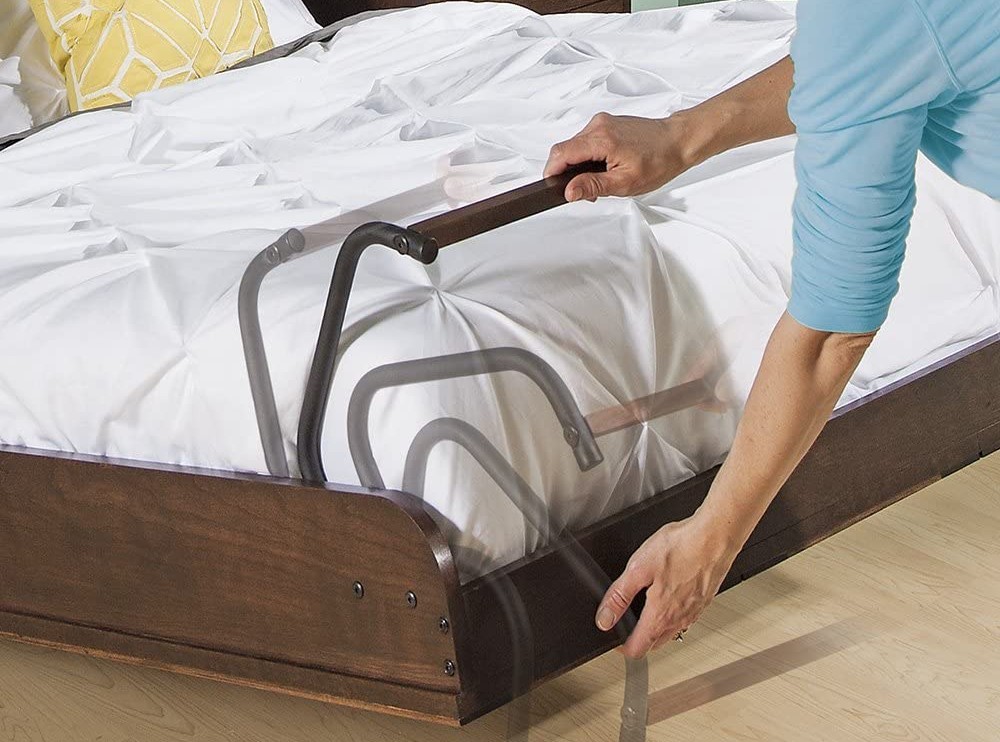 A person unfolding the legs of the best Murphy beds option to set it up for guests