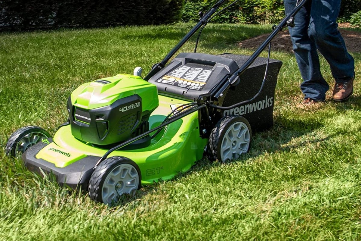 A person using the best push mower to mow a lawn.