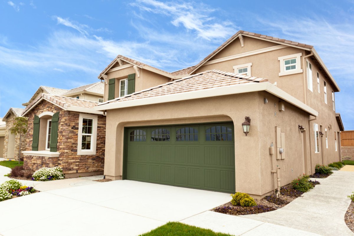 A view of a garage with a green door.