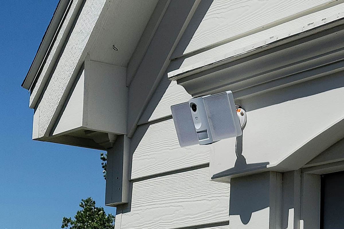 The Geeni smart floodlight camera installed outside a home