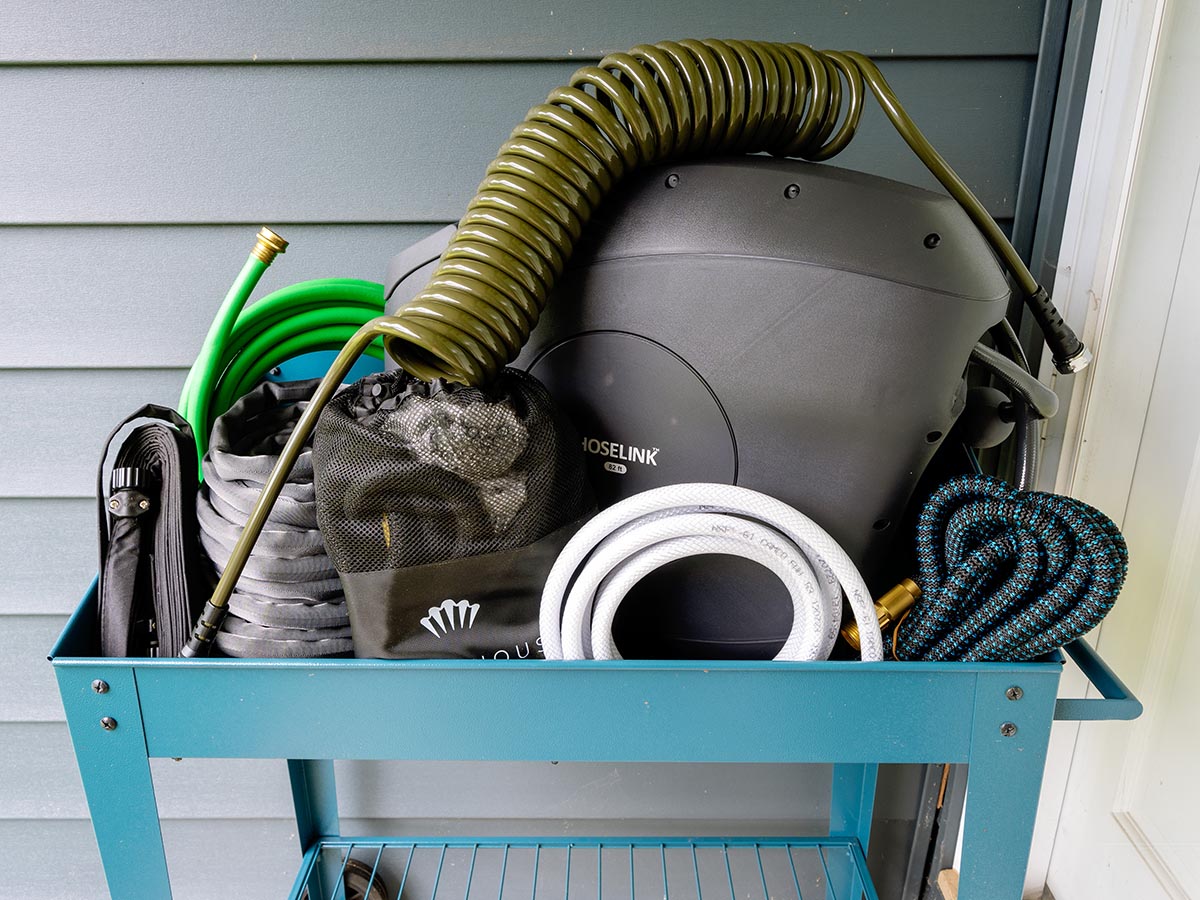 Group of Lightweight Garden Hoses inside a turquoise garden cart