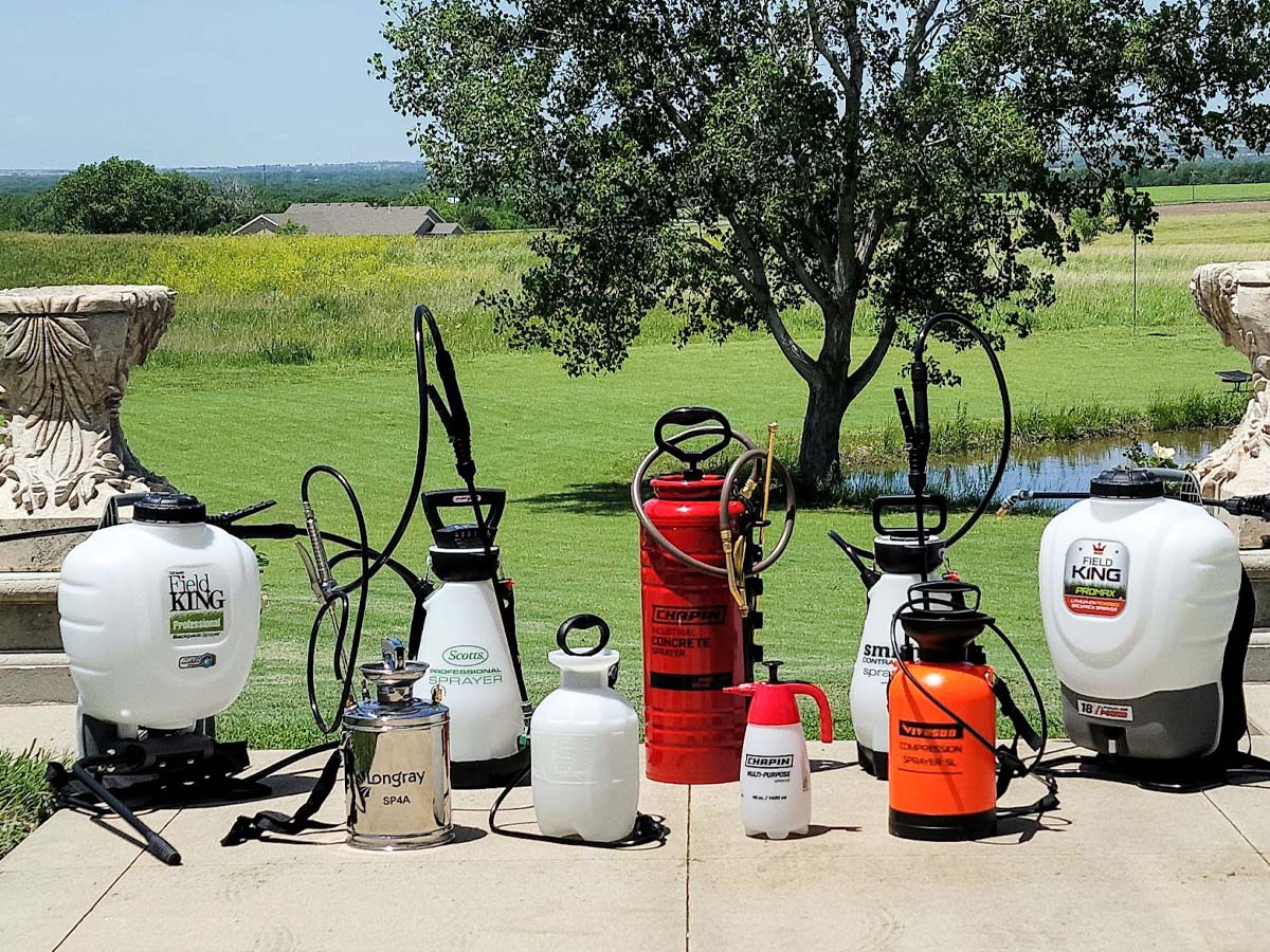 8 pump sprayers lined up on a lawn