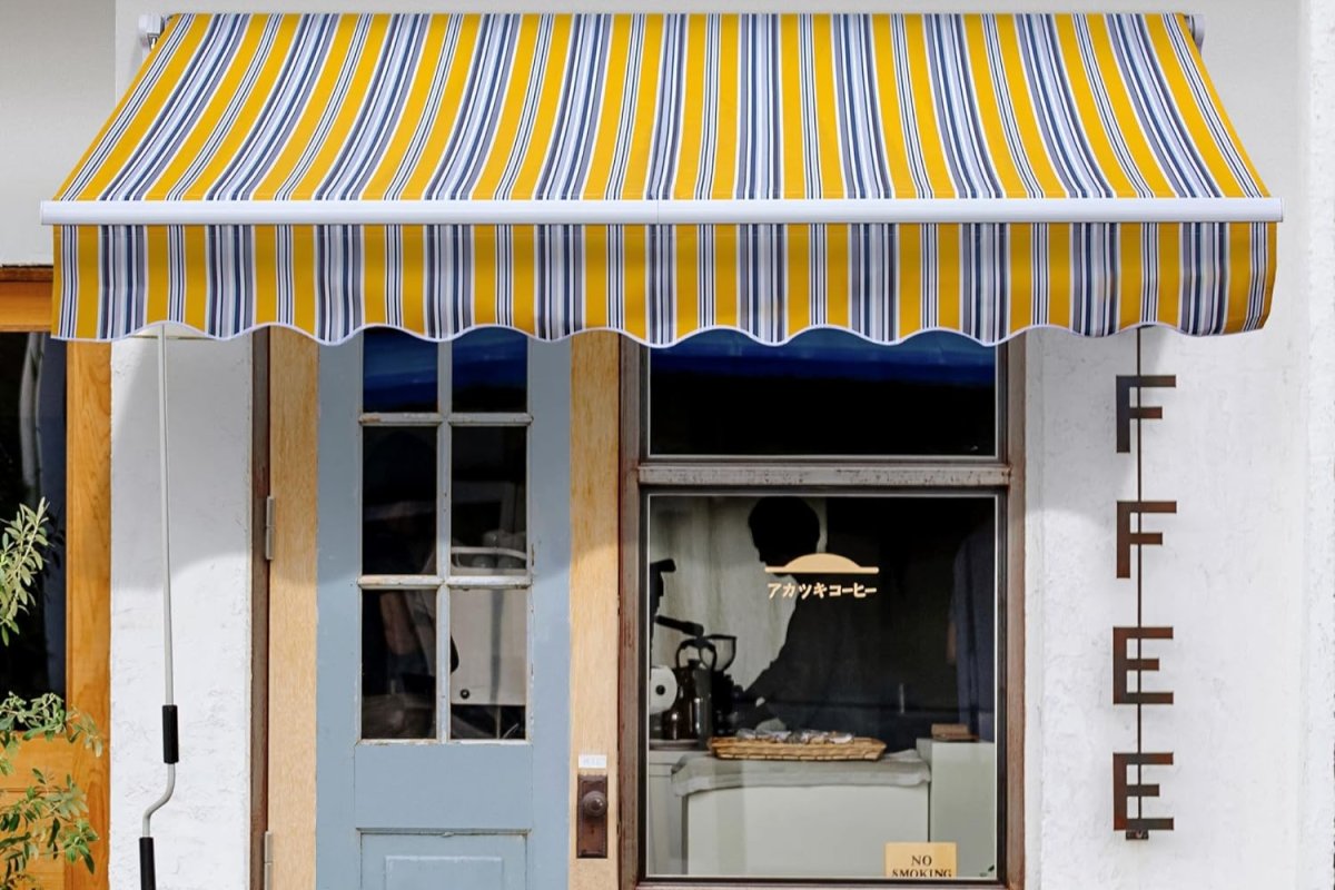 Yellow and white awning on a white building