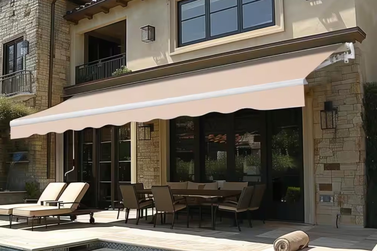 Beige retractable awning providing shade in a pool area