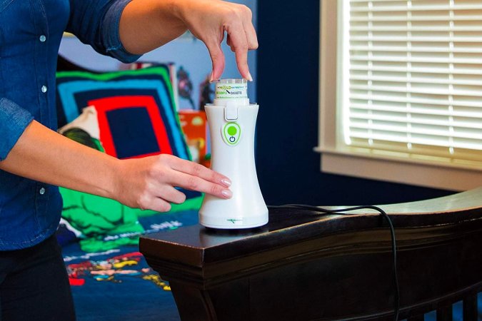 A person using the best mold test kit option in a bedroom