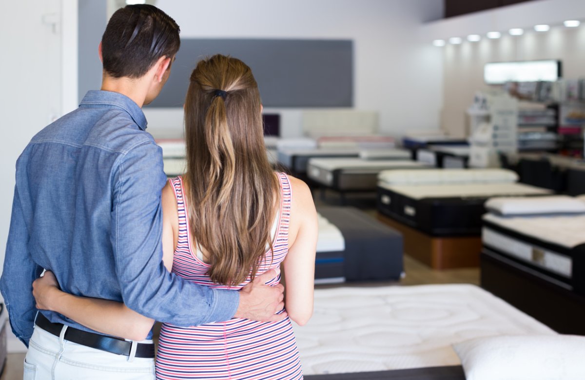 Portrait of man and woman customer in mattress store