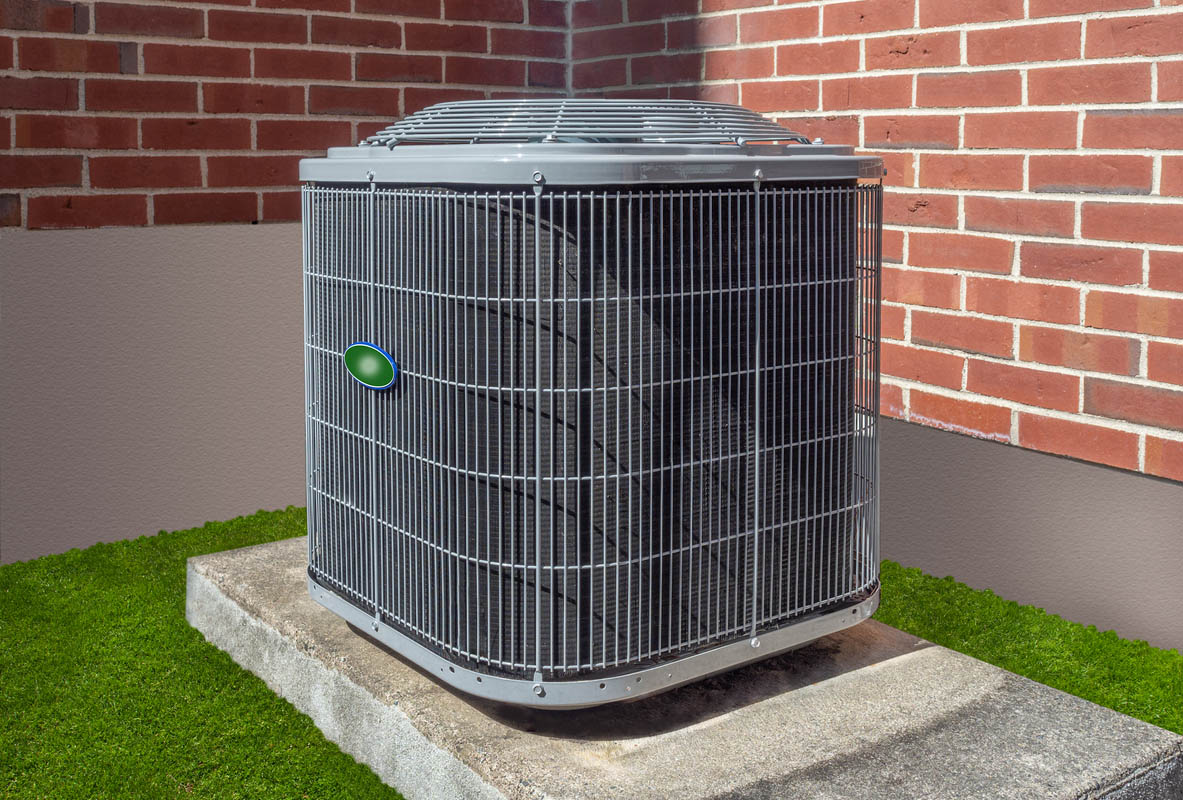 A grey central AC unit is installed outside a brick home. 