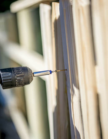 Close up of a drill and a fence.