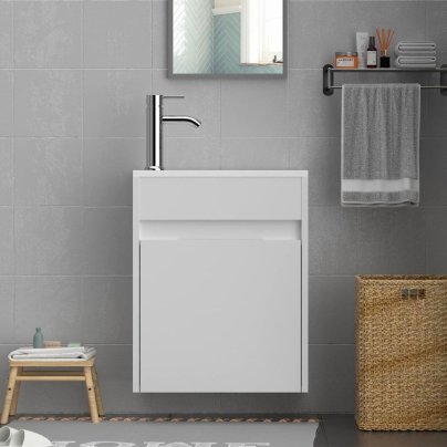 The Eclife 16-Inch Bathroom Vanity With Sink Combo installed in a modern bathroom on a grey tile wall and surrounded by natural textiles.