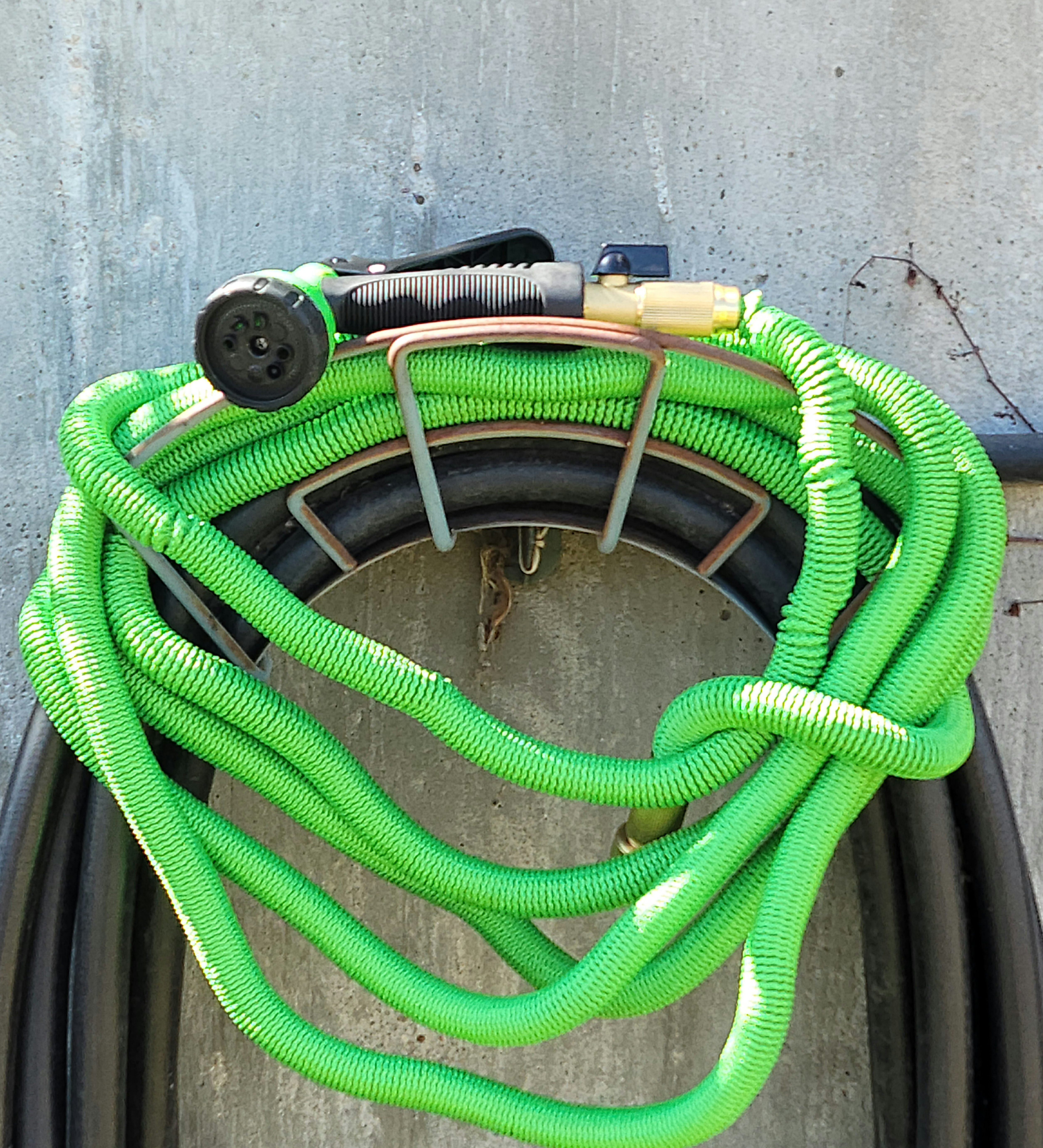 Green hose stored with nozzle