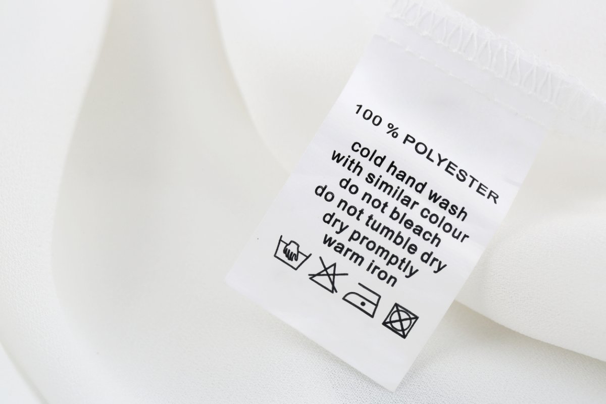 Fabric composition and washing instructions label on white shirt