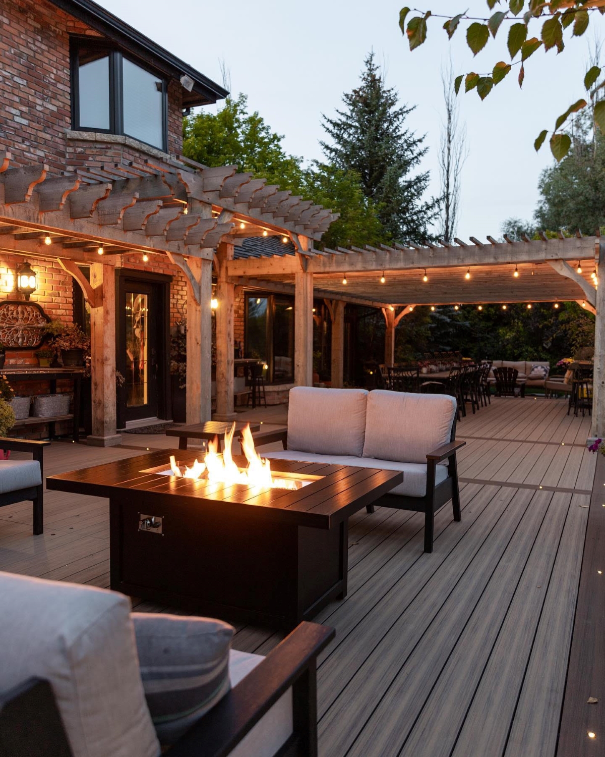 Outdoor lights hung above firepit on back patio