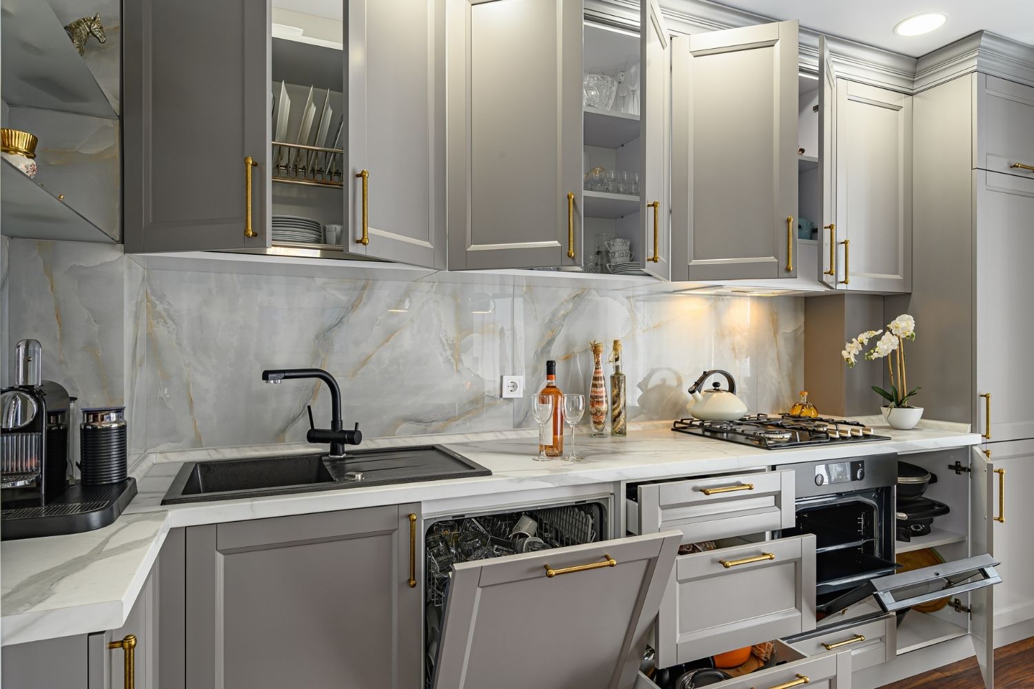 A view of a beautiful kitchen with grey cabinets. 