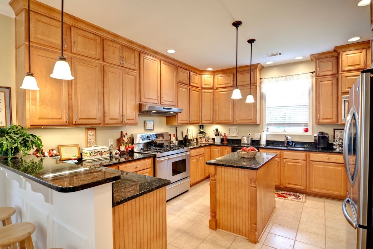 A view of a beautiful kitchen with wooden cabinets.