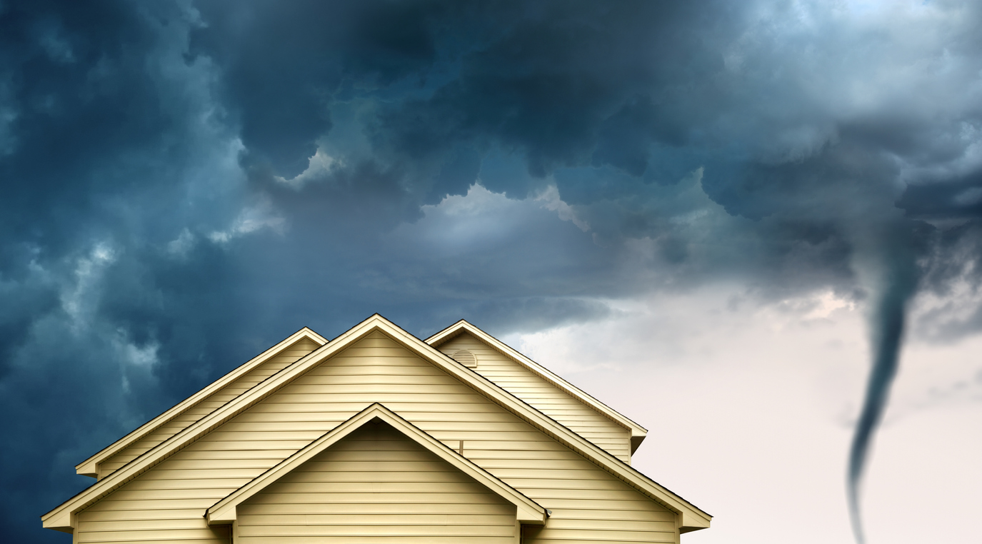 House with a tornado forming in the background