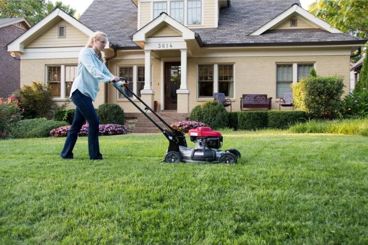 A person using the best gas mower to mow a large lawn.