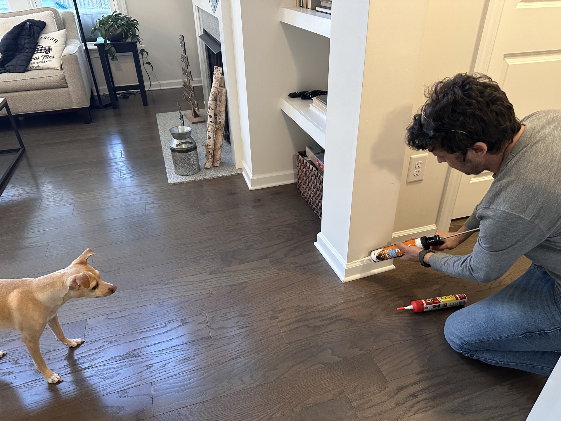 A man using one of the best caulk options for baseboard