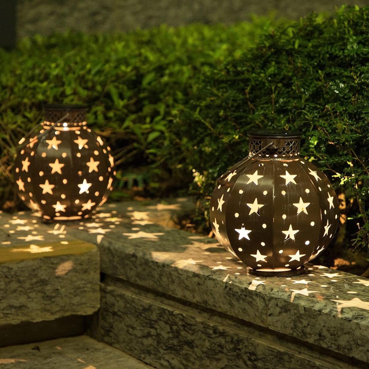 Backyard solar globe lights with star designs.